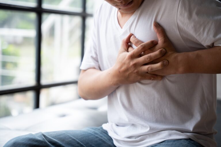 Hands holding chest with symptom heart attack disease, Man With Heart Attack.